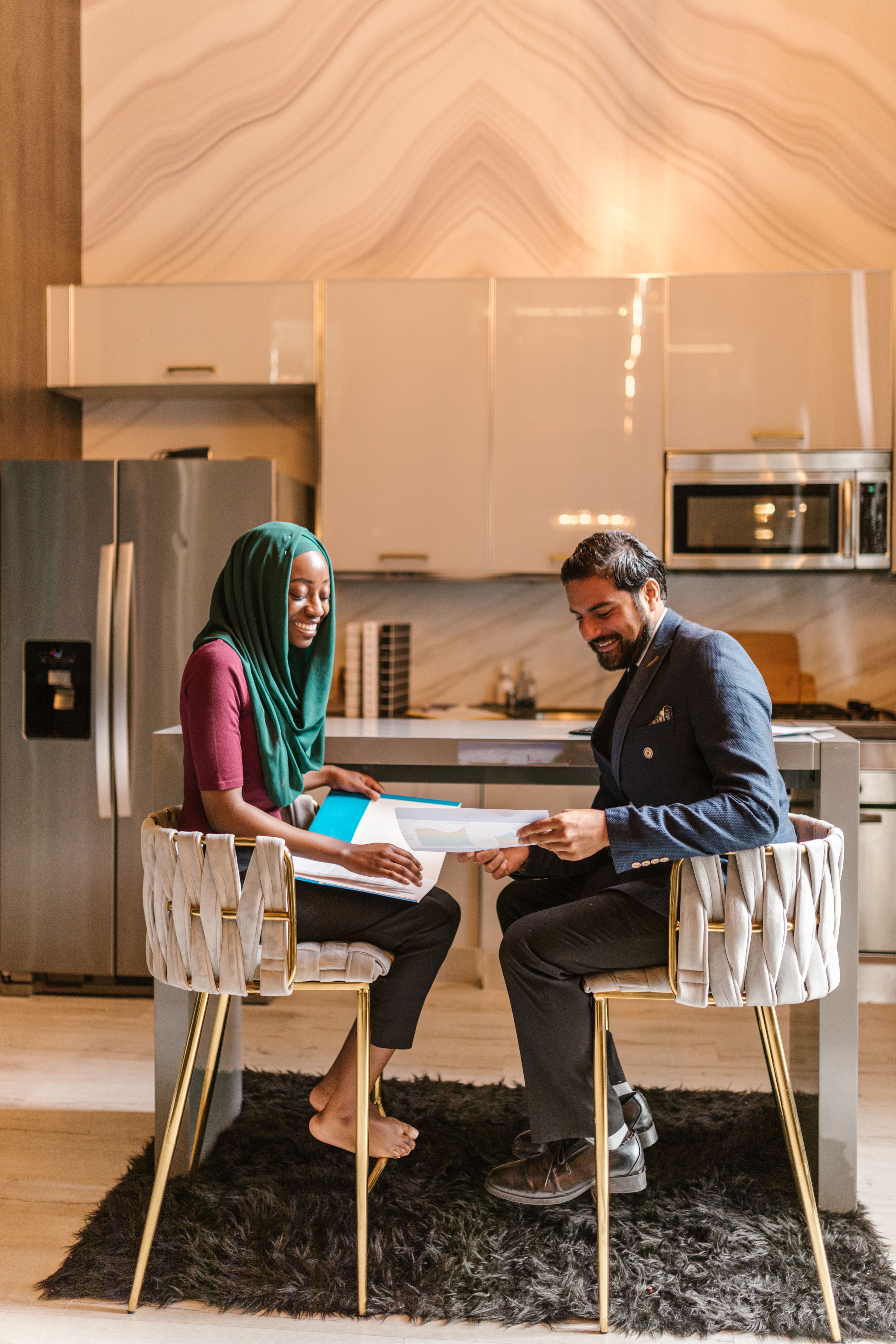 Real estate agent and client reviewing a pricing sheet in a modern office