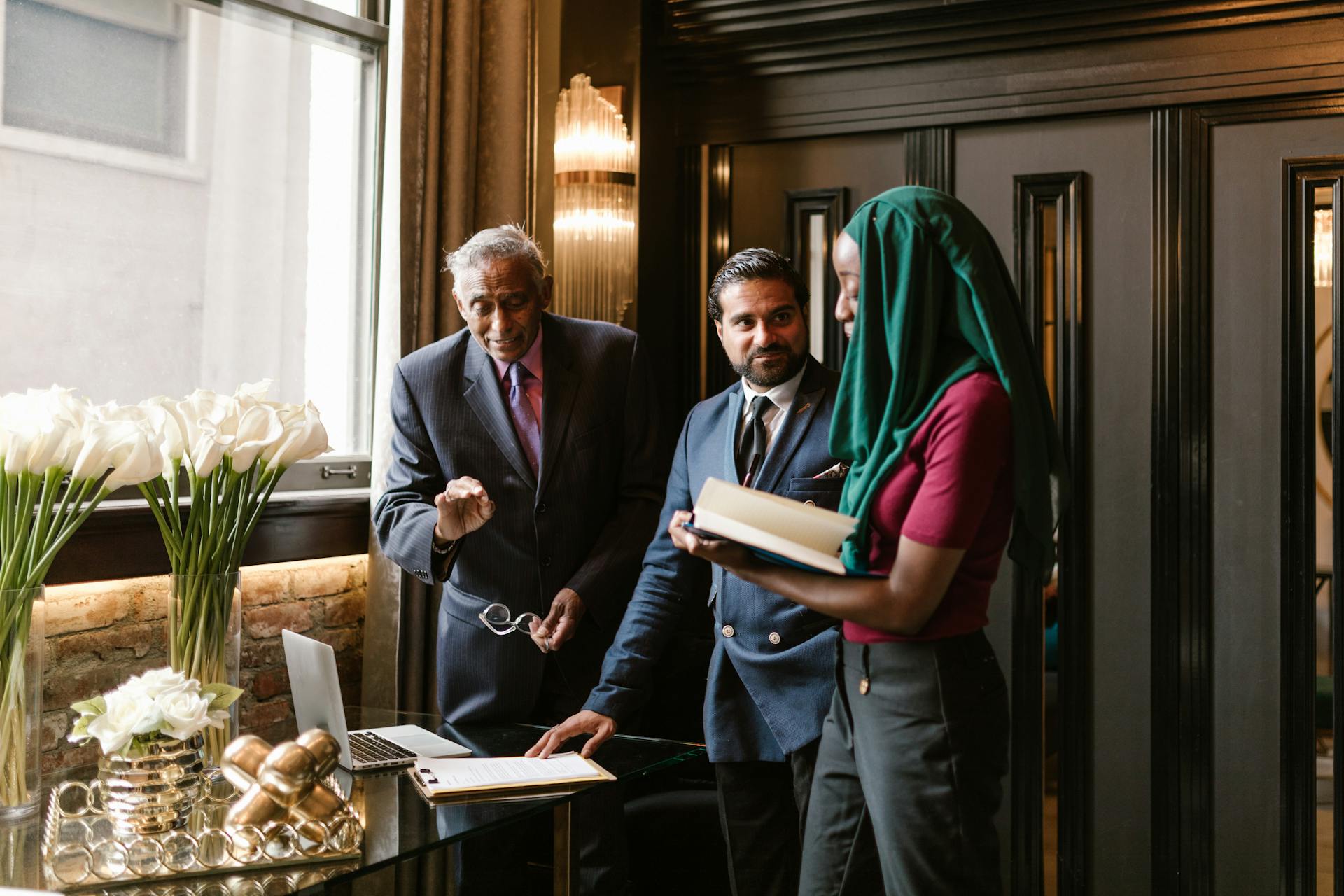 A diverse group of professionals collaborating in a modern office environment, showcasing teamwork and business strategy.