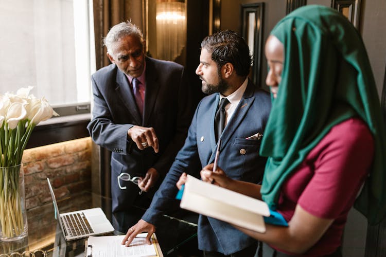 Men In Business Attire Talking To Each Other