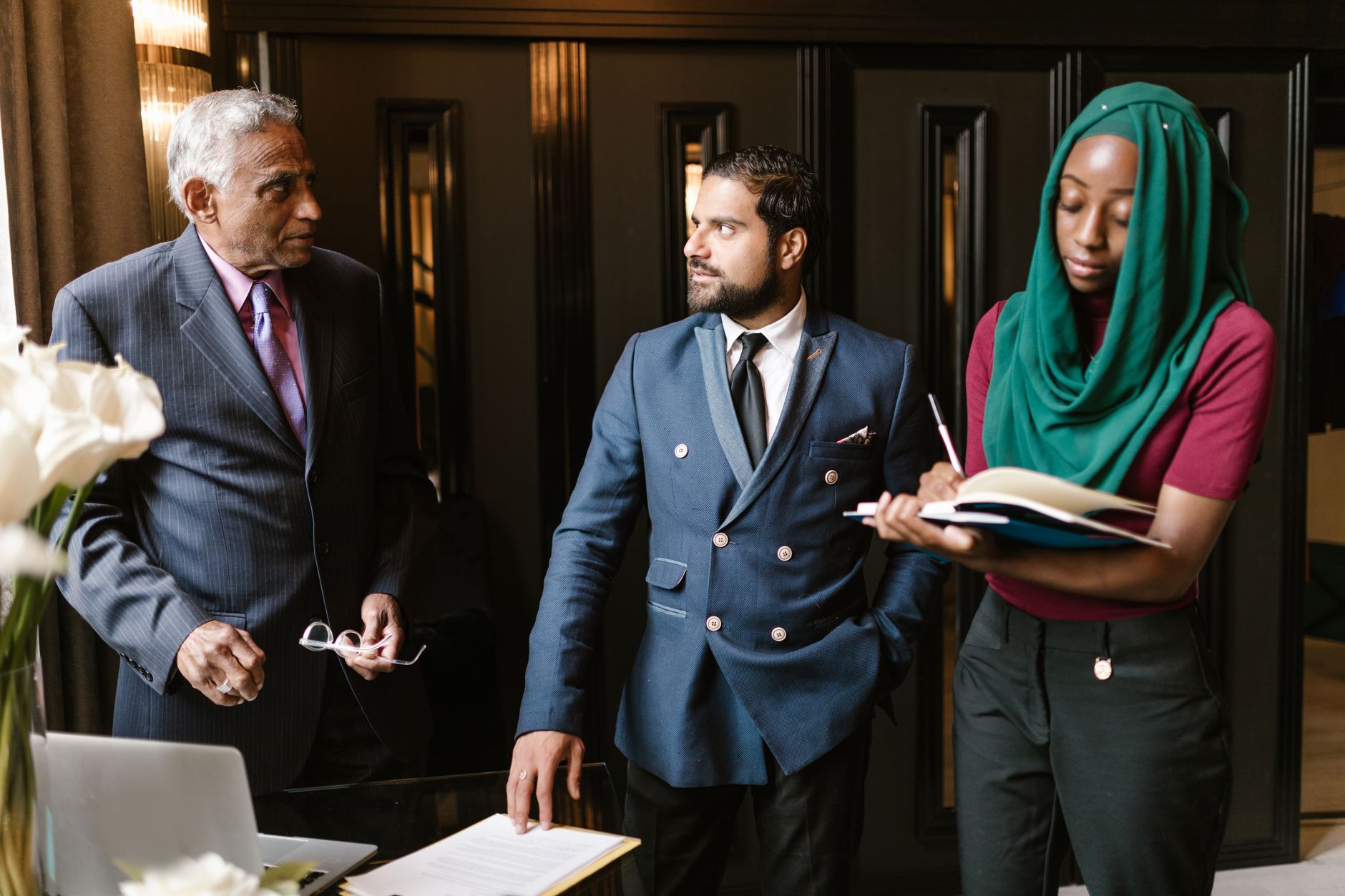 A culturally diverse team engaged in a serious business discussion in an office setting.