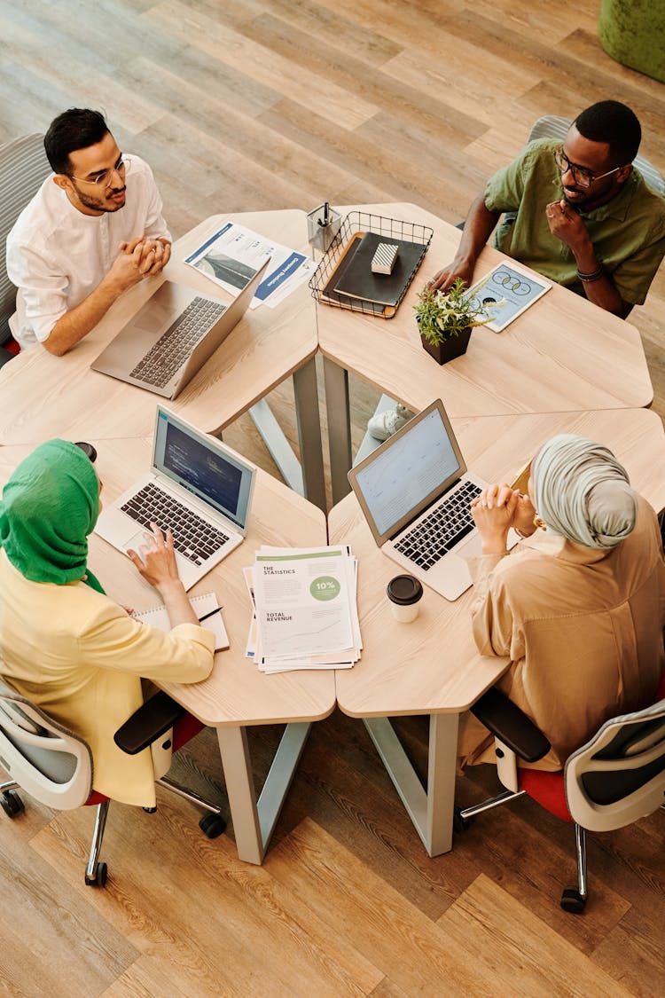 A Group Of People Sitting On The Chair While Having Conversation