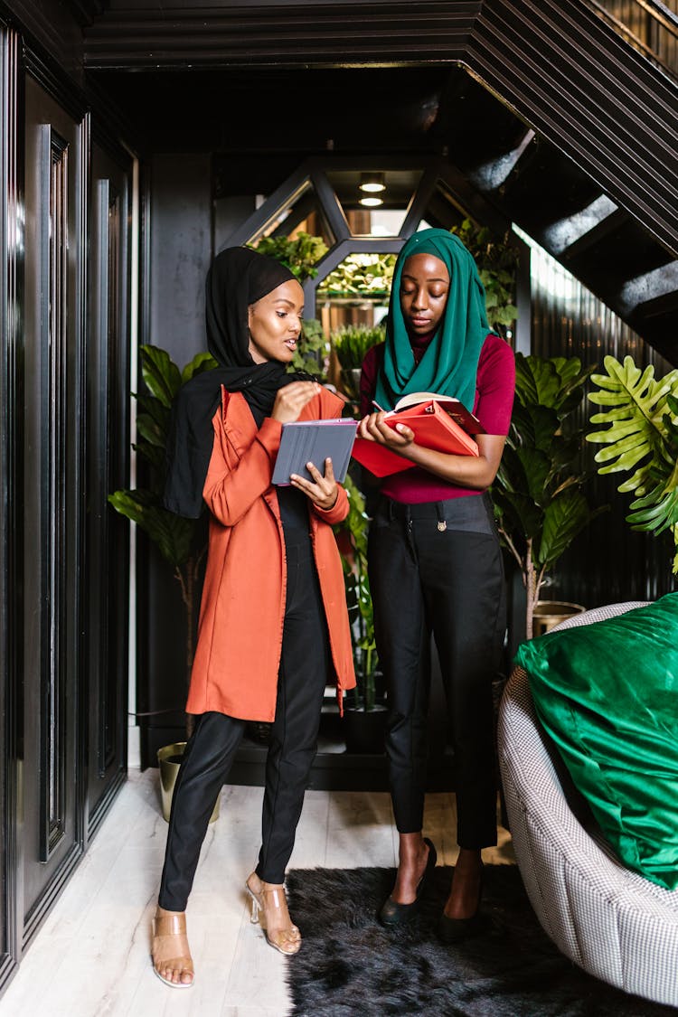 Women Wearing Headscarf Standing While Having Conversation