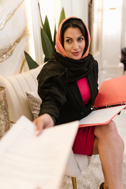 A Woman in a Hijab Holding a Document