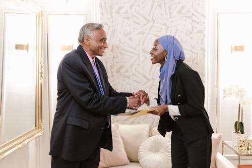 Free A Man and a Woman Shaking Hands in Doing Business Stock Photo