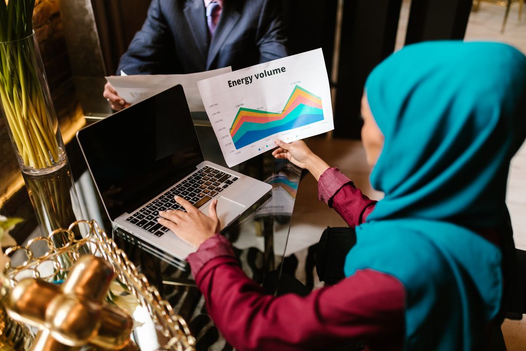 تكلفة انشاء متجر الكتروني متكامل في السعودية - Saudi entrepreneur reviewing e-commerce cost breakdown on laptop