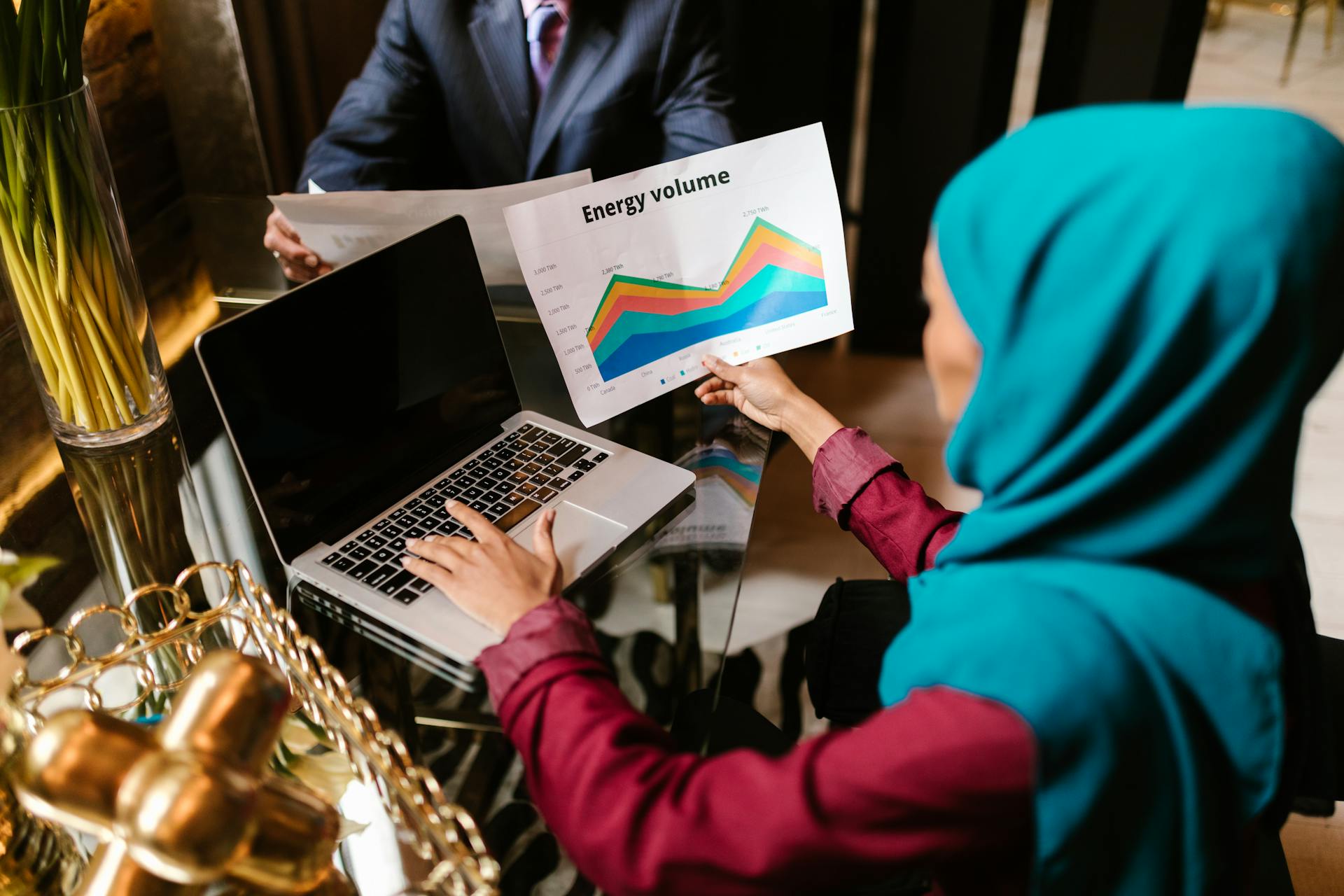 Woman Comparing Data in Office