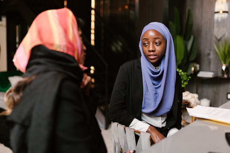 Women With Headscarves Having A Conversation 