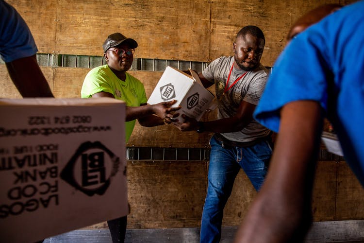 Men Carrying Boxes