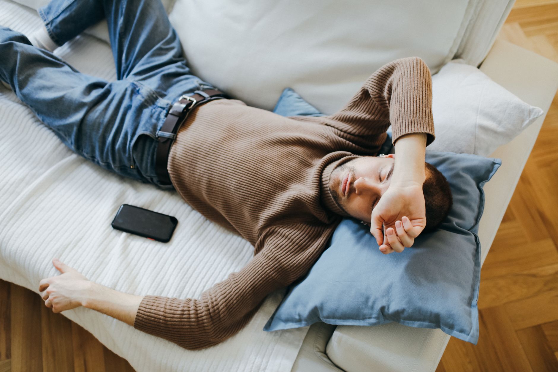 Man asleep on a sofa at home