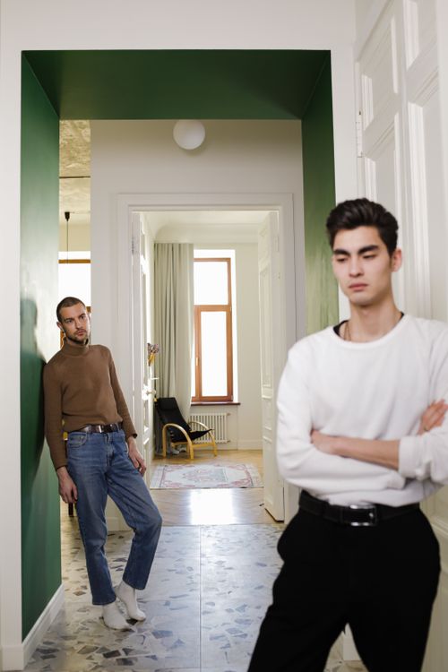 Free Contemplative interracial couple in a stylish home setting, captured indoors. Stock Photo