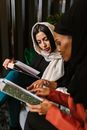 Woman in White Hijab Holding Black Tablet Computer