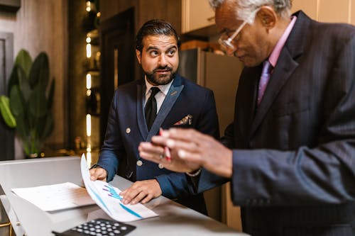 Businessmen Looking at a Graph and Talking 