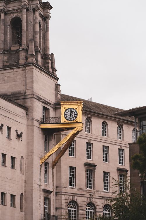 Free View of a historic clock on a classic building facade in Leeds, UK. Stock Photo