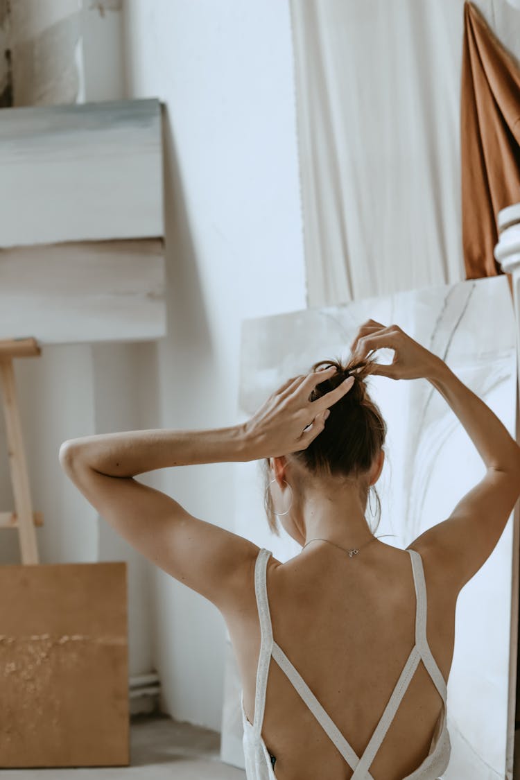 Back View Of A Woman Tying Her Hair