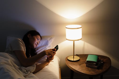 Free A Woman Looking at Her Smartphone  Stock Photo