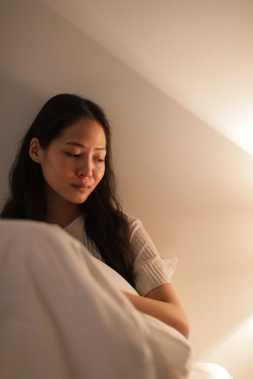 a Woman Sitting on the Bed