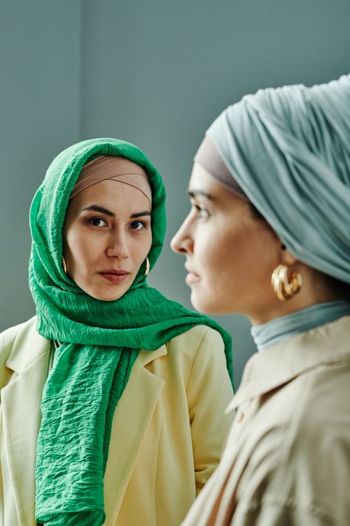 Free Stylish portrait of two women in modern modest fashion with headscarves. Stock Photo