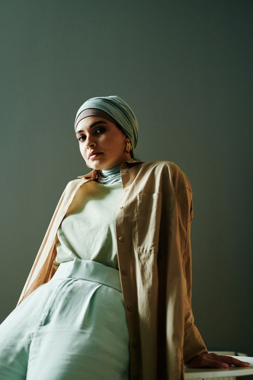Free Stylish woman wearing light-colored hijab and modern outfit, showcasing elegant fashion. Stock Photo