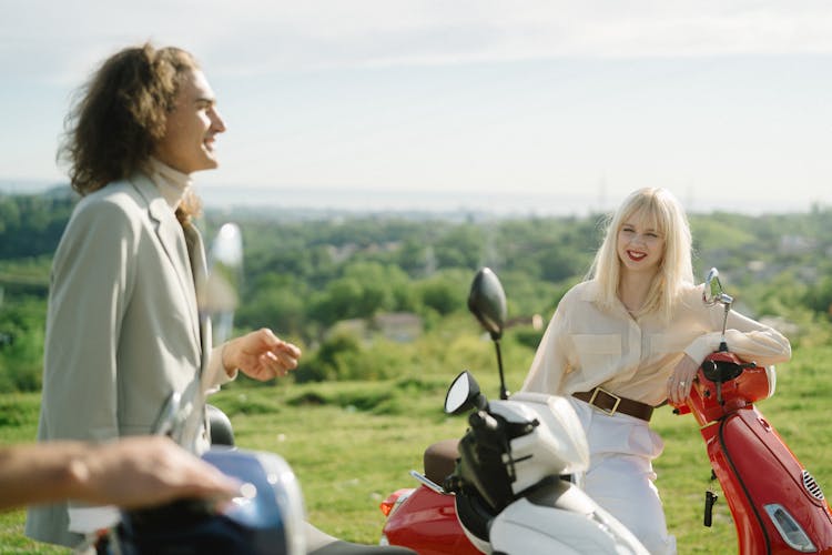 People Enjoying An Outdoor Ride With Their Scooters