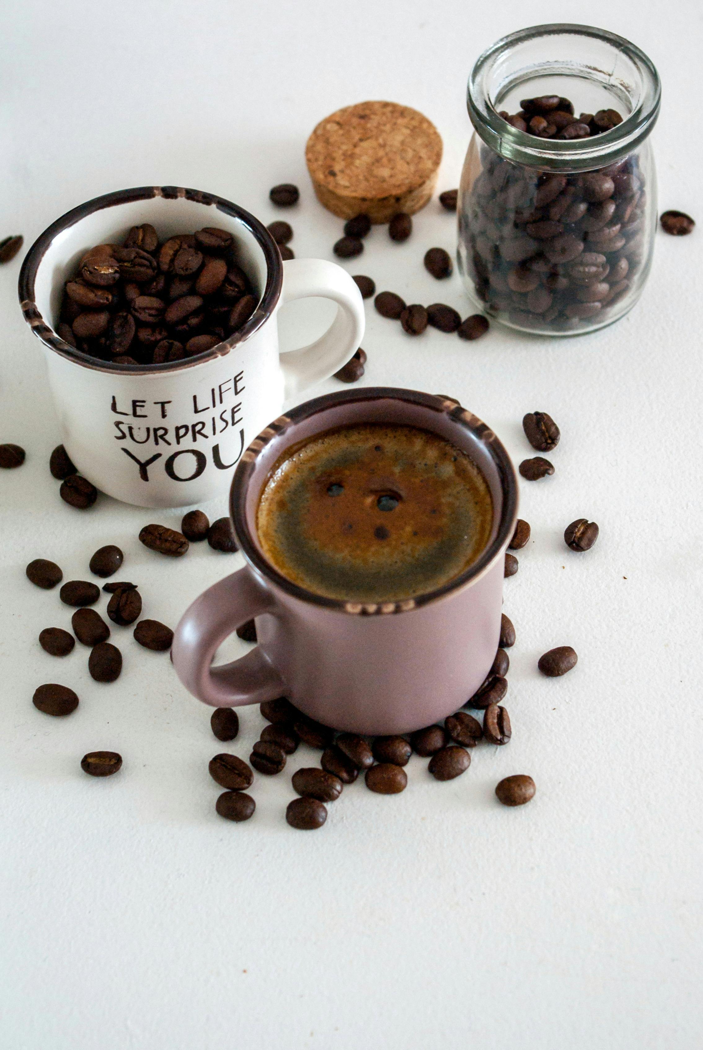 Flat lay of coffee mugs and beans, perfect for a cozy and inviting theme.