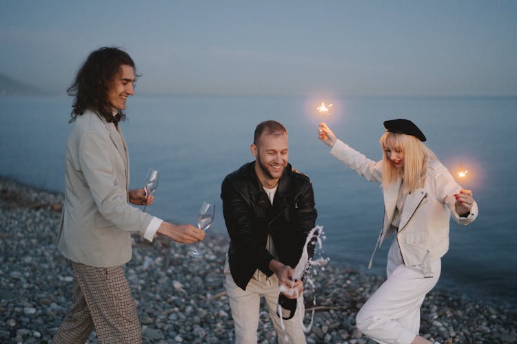 A Group Of Friends Celebrating At The Beach