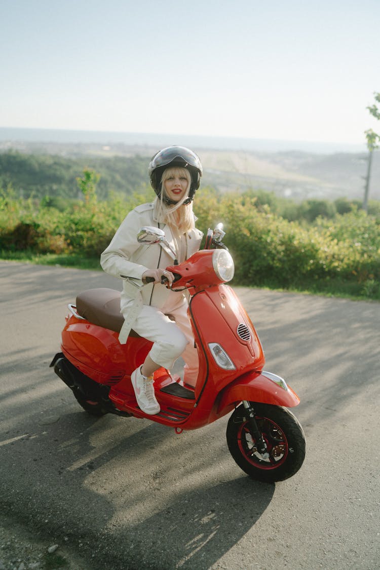 Woman Riding Red Moped