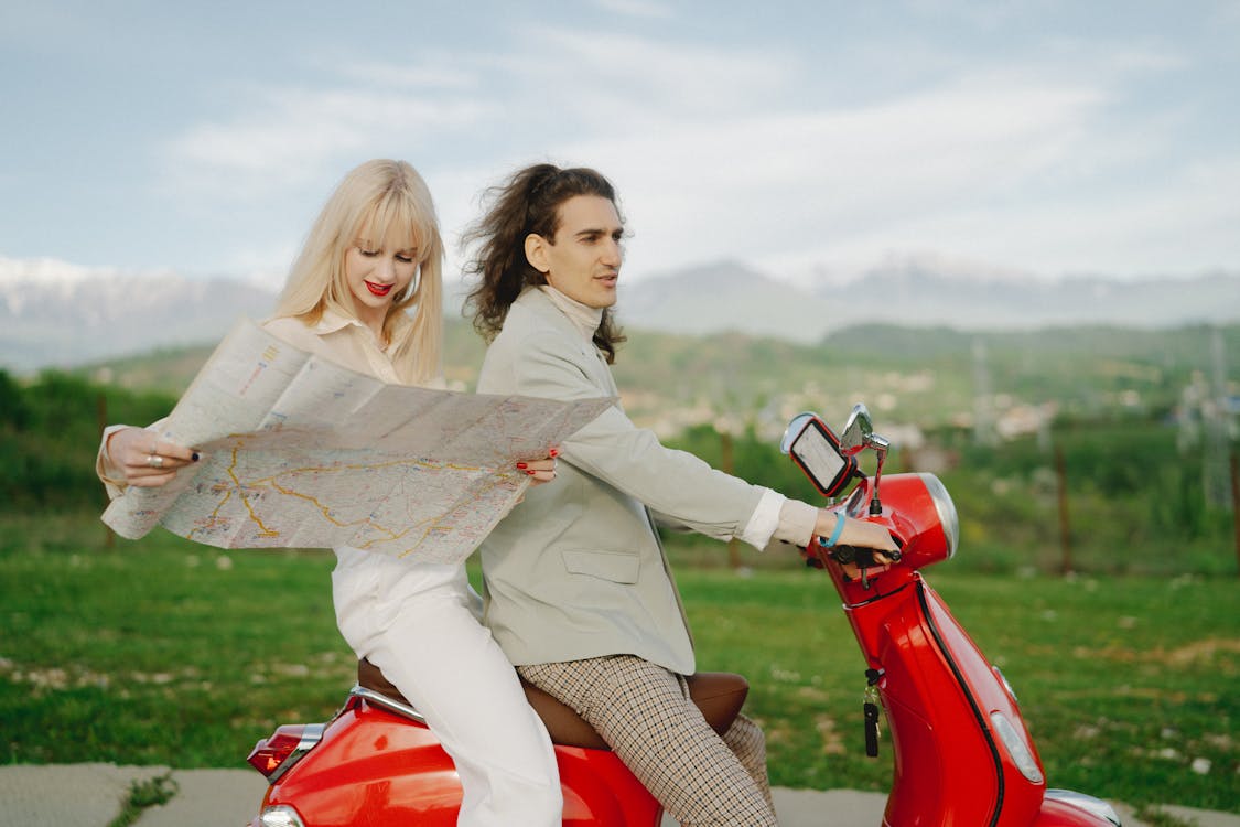 Free Couple Riding Red Moped Stock Photo