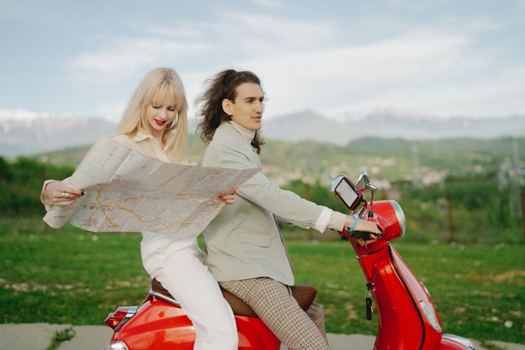 Couple Riding Red Moped