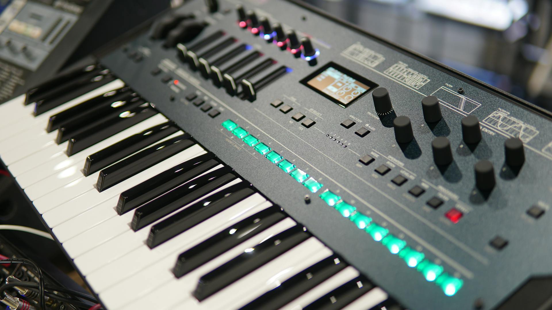 Detailed view of electronic music synthesizer with keys and control knobs.