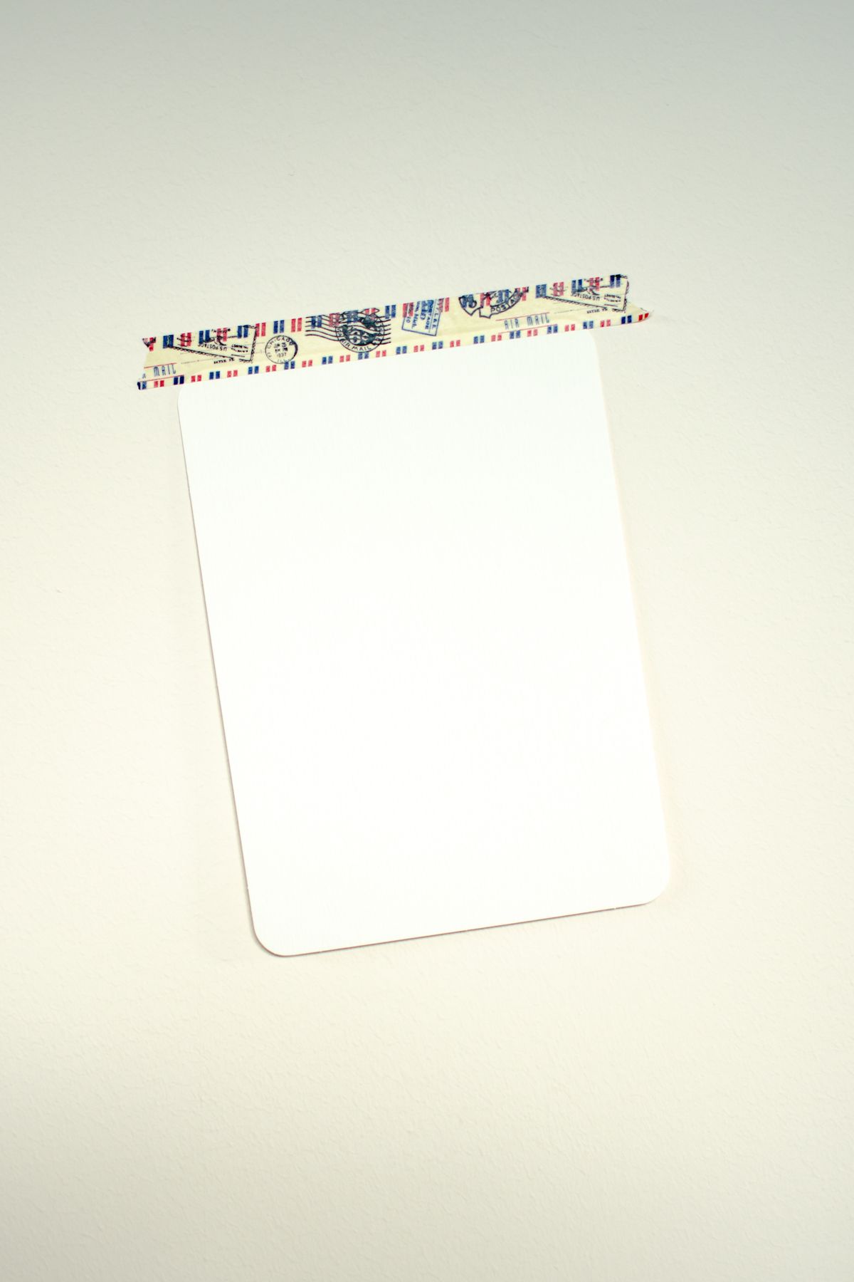 Blank card taped to a surface, ready to become a duct tape picture frame