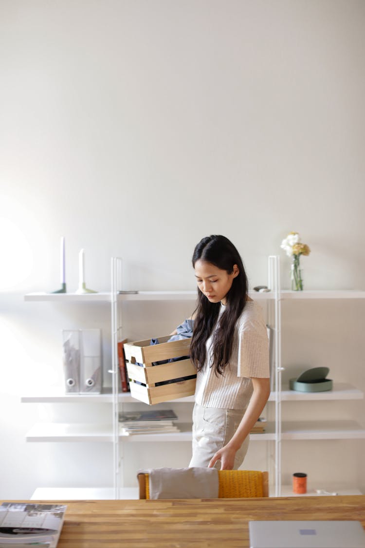 Woman Carrying A Wooden Crate Doing House Chore