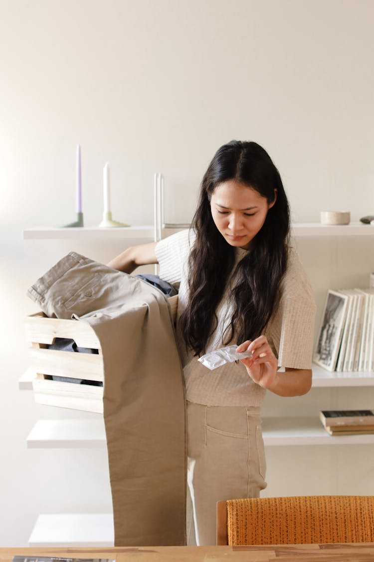 Woman Looking At The Unused Condoms