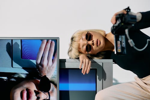 Photo of Woman Leaning on Top of Television