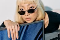 Close Up Photo of Woman Leaning on a Monitor