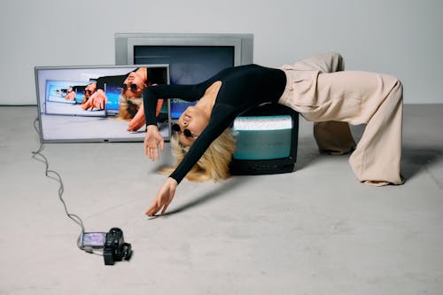 Photo of Woman Laying on Top of Monitor