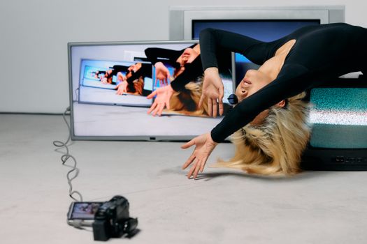Photo of Woman Laying on Top of Television