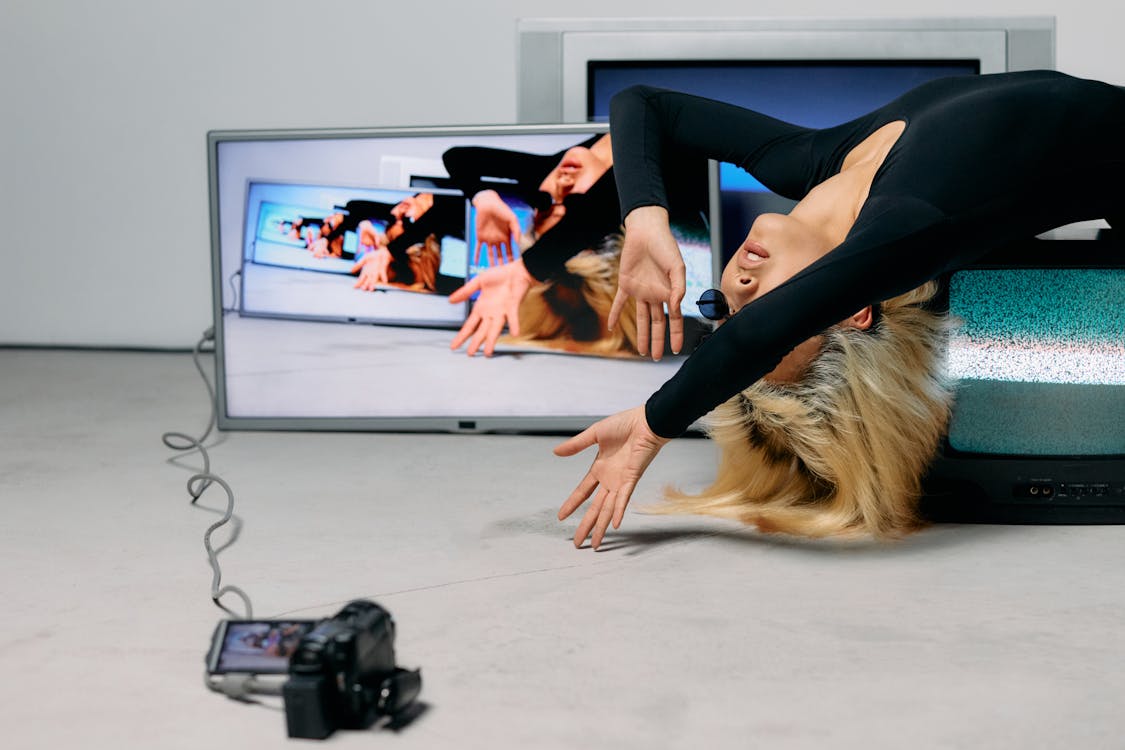 Photo of Woman Laying on Top of Television