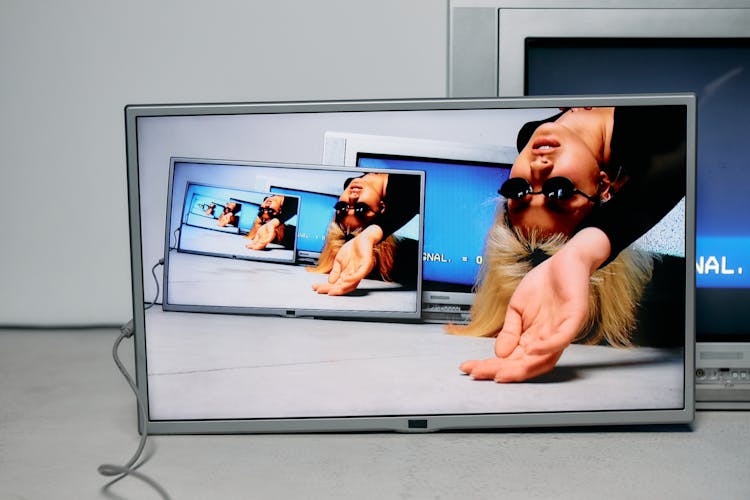 Photo Of Repetitive Images Of Woman On A Monitor