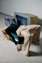 Photo of Woman Laying on Top of Television