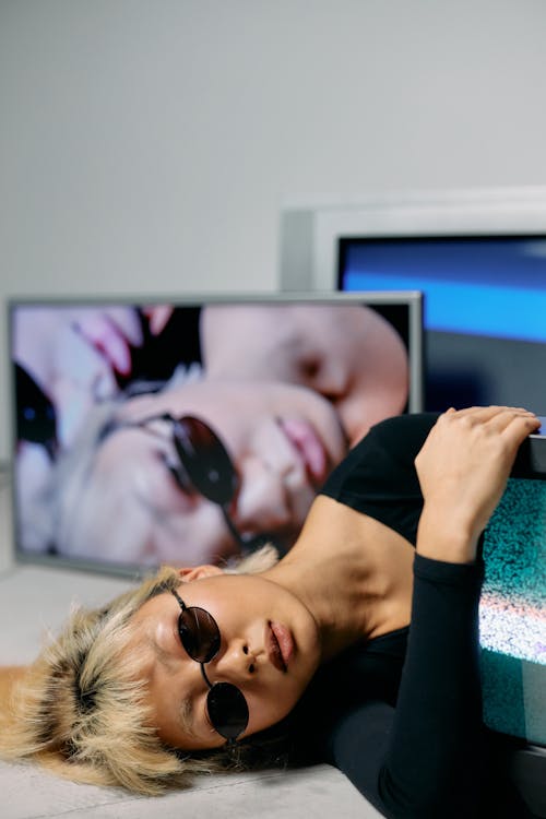 Woman in Black Tank Top Wearing Black Sunglasses