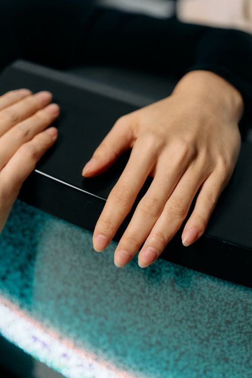 Free Artistic close-up of hands with manicured nails on a vintage CRT television, captured with selective focus. Stock Photo
