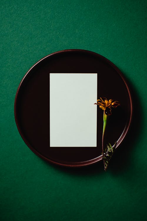 White Paper and a Flower on a Round Tray