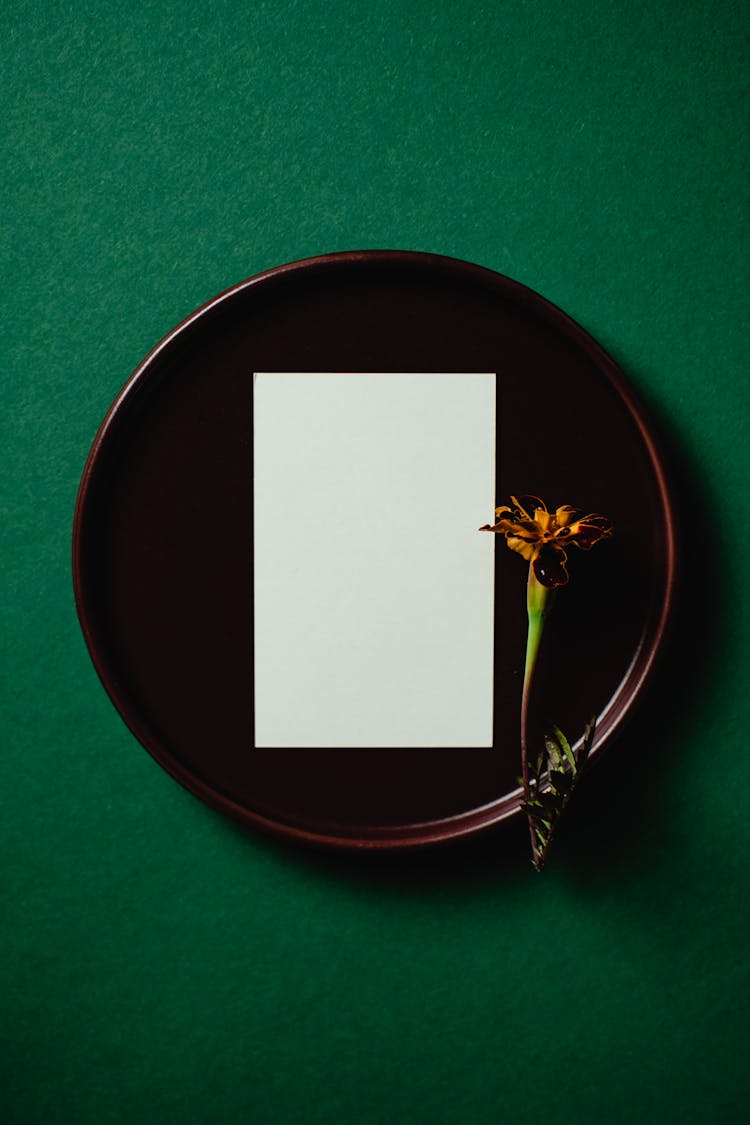 White Paper And A Flower On A Round Tray
