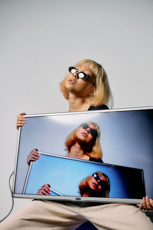 Free Photo of Woman Holding a Television Stock Photo