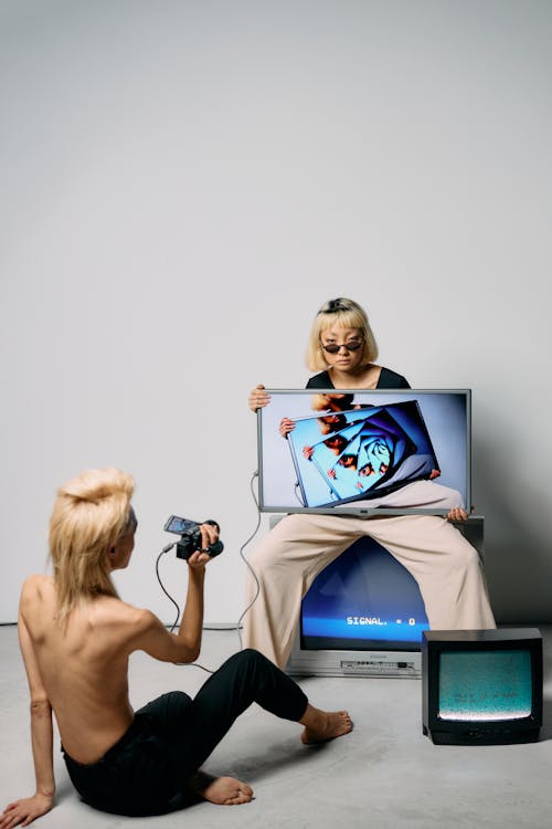 Free Photo of Woman Sitting on a Television Stock Photo
