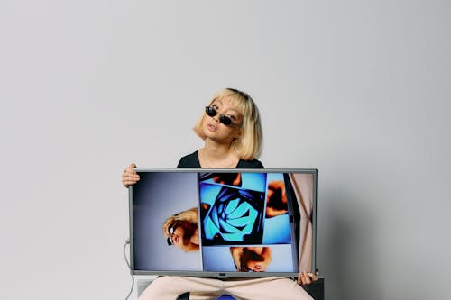 Photo of Woman Holding Monitor