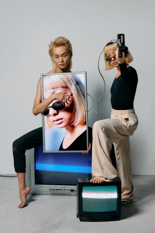 Photo of Man Sitting on a Television