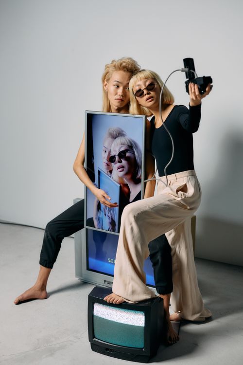 Free Fashion models posing with retro technology, showcasing modern style and expression. Stock Photo
