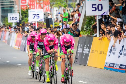 Man in Pink Shirt Riding Bicycle