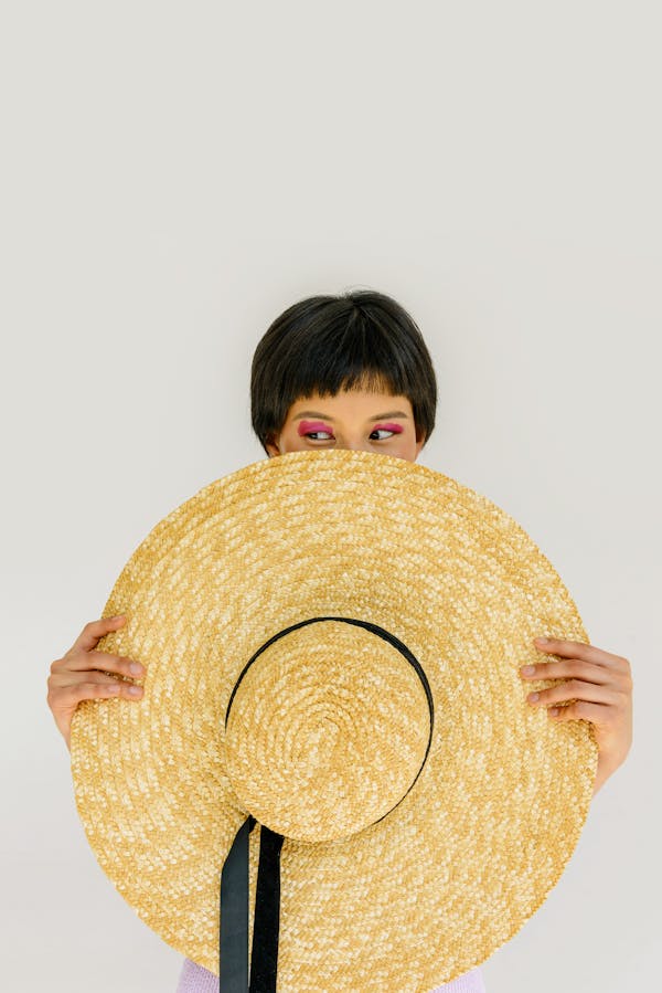 A Woman with Short Hair Holding a Hat